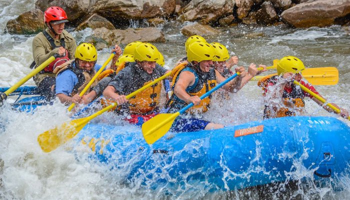 Blue Sky Rafting guests paddle through the Class III Shoshone Rapids on the Colorado River in Glenwood Canyon near Glenwood Springs, Colorado.