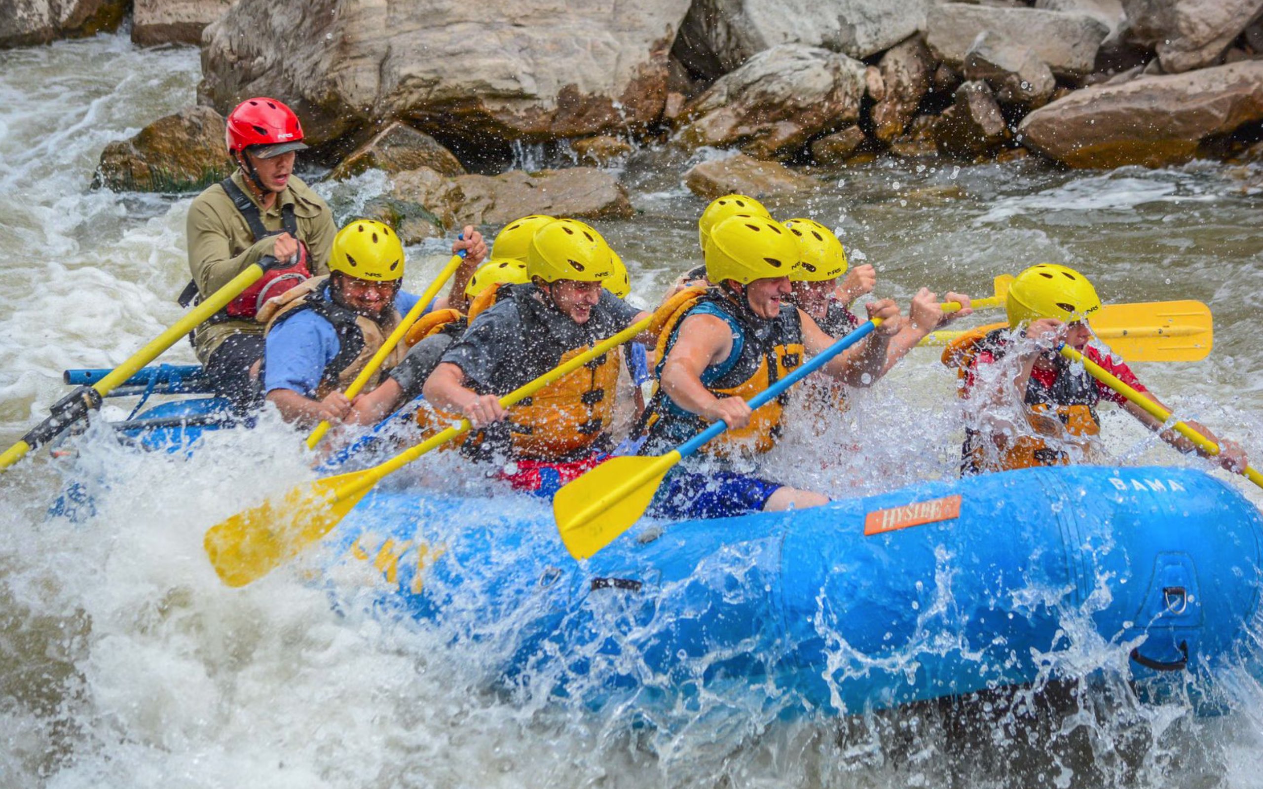 Guests tackle the Class III Shoshone Rapids during Blue Sky Rafting's Early Bird Rafting Special on the Colorado River in Glenwood Canyon.